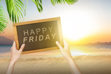 A human hand holding a blackboard with a Happy Friday text. Happy Friday conceptの写真素材