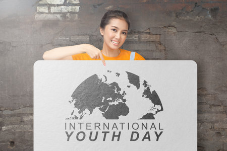 Woman showing international youth day message. International Youth Day conceptの写真素材