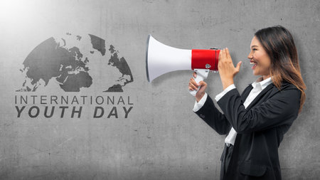 Businesswoman holding a megaphone shouting. International Youth Day conceptの写真素材