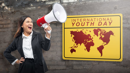 Businesswoman holding a megaphone shouting. International Youth Day conceptの写真素材