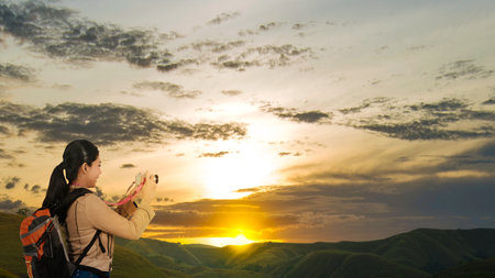 Asian woman with a backpack holding the camera. World Photography Dayの写真素材