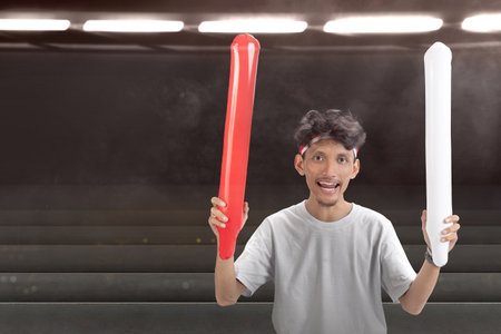 Indonesian man supporting the team when competing. Indonesian independence dayの写真素材