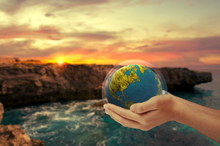 Human hand holding earth with layer protect. World ozone day conceptの写真素材