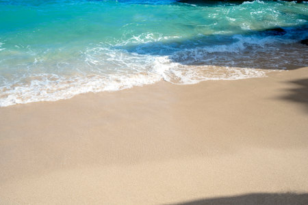 Sandy beach with the blue ocean and blue sky backgroundの写真素材