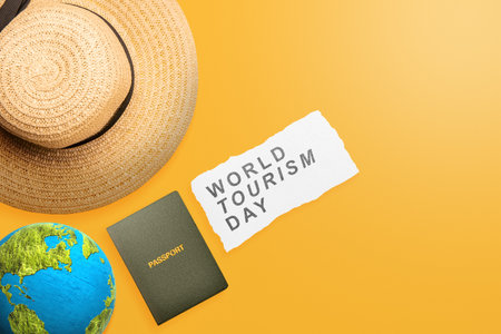 Hat with passport and globe on a colored background. World tourism day conceptの写真素材