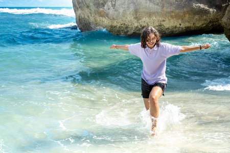 Asian woman traveling on the beach with blue sky backgroundの写真素材