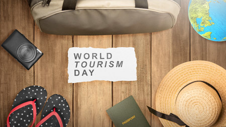 Bag with passport and camera on a wooden background. World tourism day conceptの写真素材