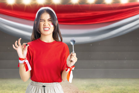 Indonesian girl celebrate Indonesian independence day on 17 August with a marbles race using a spoon. Indonesian independence dayの写真素材