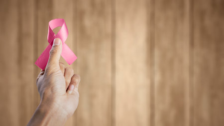 Human hand showing pink awareness ribbon. Breast cancer awareness conceptの写真素材