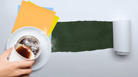 A human hand pouring a coffee with empty paper on torn paper background. International coffee day conceptの写真素材