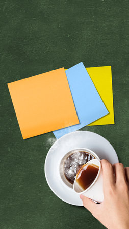 A human hand pouring a coffee with the empty paper. International coffee day conceptの写真素材