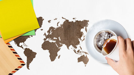 A human hand is pouring a coffee with the empty paper. International coffee day conceptの写真素材