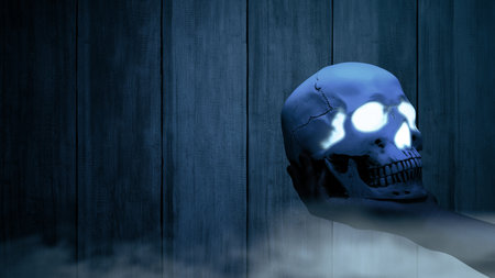 Hand holding human skull head with night scene background. Scary skull Halloween conceptの写真素材