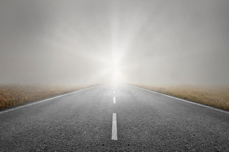 Asphalt road with dramatic sky backgroundの写真素材