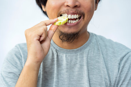 Man eating cucumber with a white background. Traditional Indonesia foodの写真素材