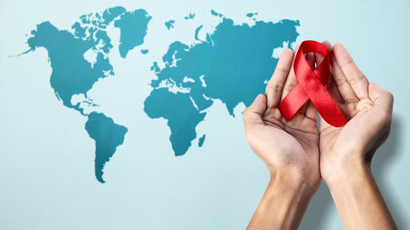 Human hand showing red ribbon awareness. World Aids Day concept