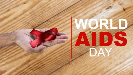 Human hand showing red ribbon awareness. World Aids Day concept