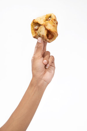 A human hand holding a side dish with a white background