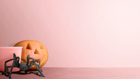 Jack-o-Lantern and spider on a colored background. Cute Halloween Wallpaper conceptの写真素材