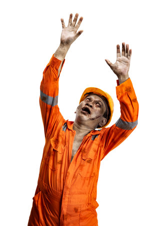 A scary construction worker zombie with blood and wounds on his body walking isolated over a white backgroundの写真素材