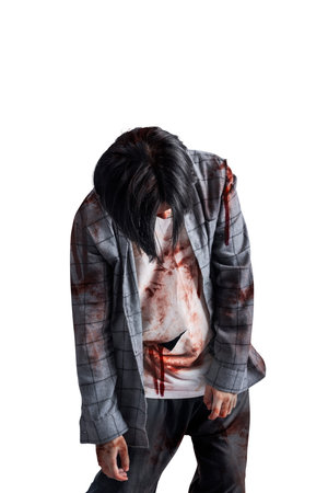A scary zombie with blood and wounds on his body walking isolated over a white backgroundの写真素材