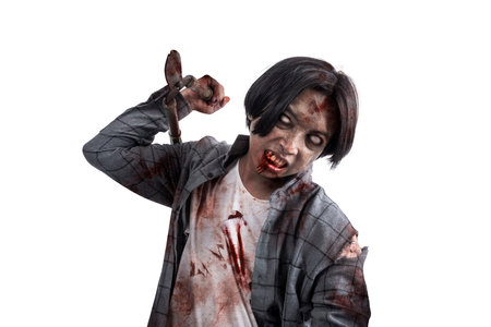 A scary zombie with blood and wounds on his body walking while carrying a grass cutter isolated over a white backgroundの写真素材