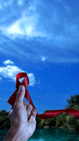 Human hand showing red ribbon awareness. World Aids Day conceptの写真素材