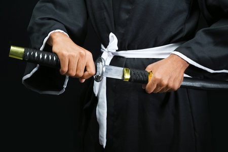 Samurai warrior gripping the sword with a black background