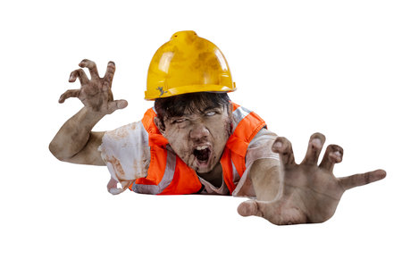 A scary construction worker zombie with blood and wounds on his body crawling isolated over a white backgroundの写真素材