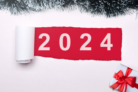 2024 on ripped paper. Happy New Year 2024の写真素材