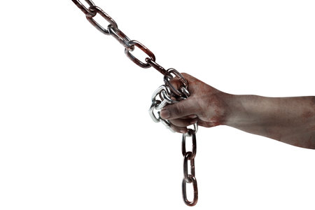 The hand of a scary zombie with blood and wounds tied on the iron chain is isolated over a white...