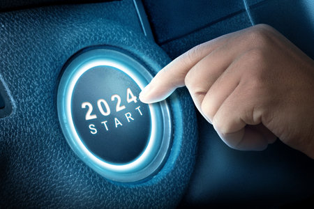 Human hand hit the 2024 button to start the new year. Happy New Year 2024