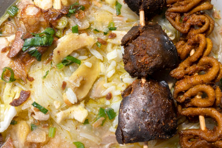 Chicken soup (Soto Ayam) with intestine and liver satay is ready to serve. Traditional Indonesia foodの写真素材