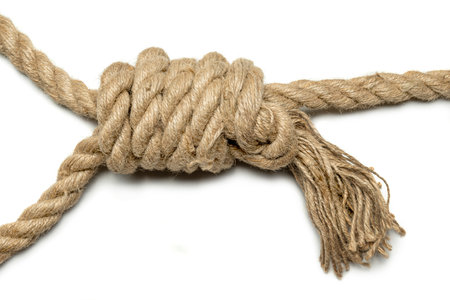 Coiled rope knot isolated over a white backgroundの写真素材