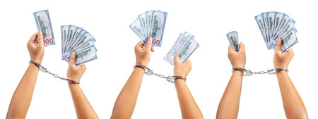 A human hand in handcuff holding money isolated over a white background