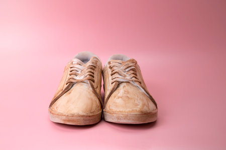 Closeup view of dirty white sneakers on a colored backgroundの写真素材