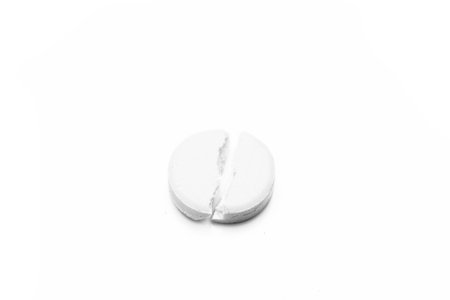 Broken pill isolated over a white background. Healthcare and medicine conceptの写真素材