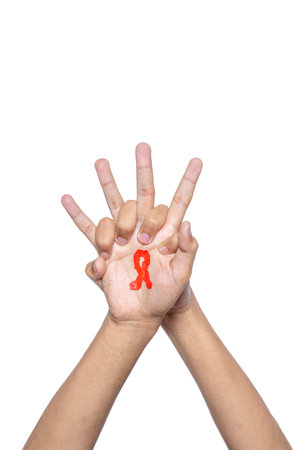 The human hand shows a red ribbon awareness symbol. World Aids Day concept
