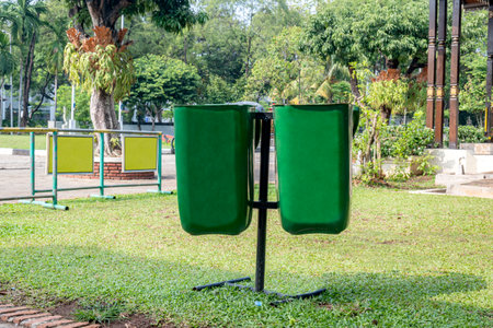 Green garbage bins hanging in the parkの写真素材