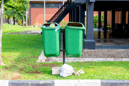 Green garbage bins hanging in the parkの写真素材