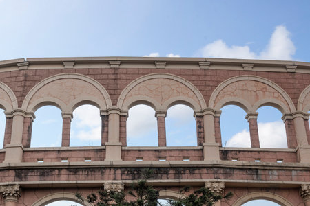 View of building window arch with blue sky backgroundの写真素材