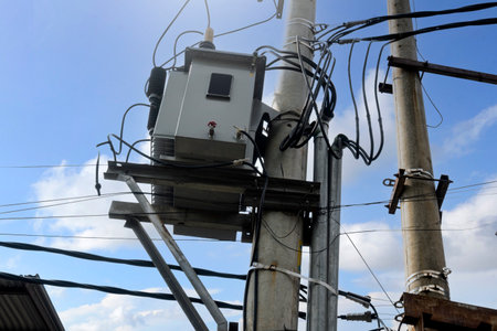 High voltage power lines tower with a blue sky background