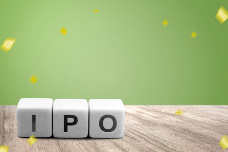 A row of small cubes with IPO letters on a wooden table. Stock investment conceptの写真素材