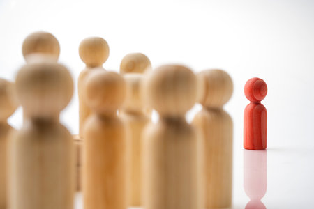 Closeup view crowd of wooden figures isolated over a white backgroundの写真素材