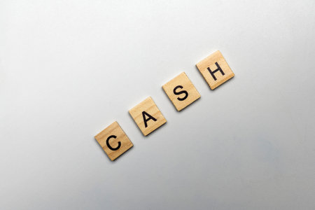 A row of wooden cubes with CASH letters. The financial and economic conceptの写真素材