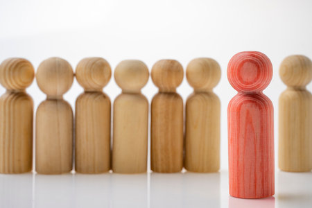 Closeup view row of wooden figure isolated over white backgroundの写真素材