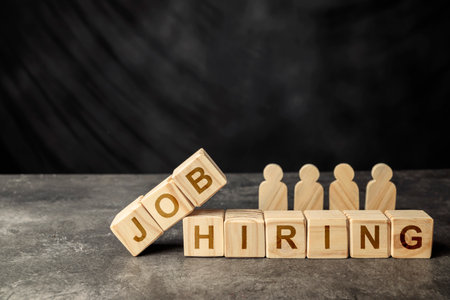 Wooden figures and cubes with JOB HIRING letter. Human resources management conceptの写真素材