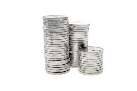 Closeup view stack of silver coins isolated over white backgroundの写真素材