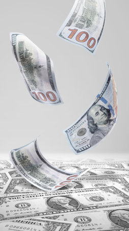 Closeup view of a pile of cash money with flying money. Financial concept