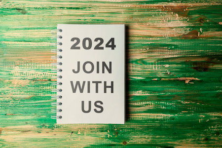 Notebook with 2024 Join With Us text on wooden table. Looking for a new job on new year. Human...